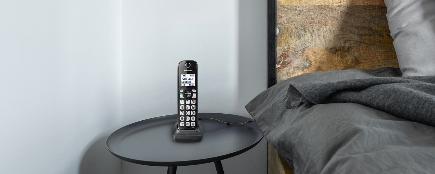 A telephone accessory sits on a bedside table