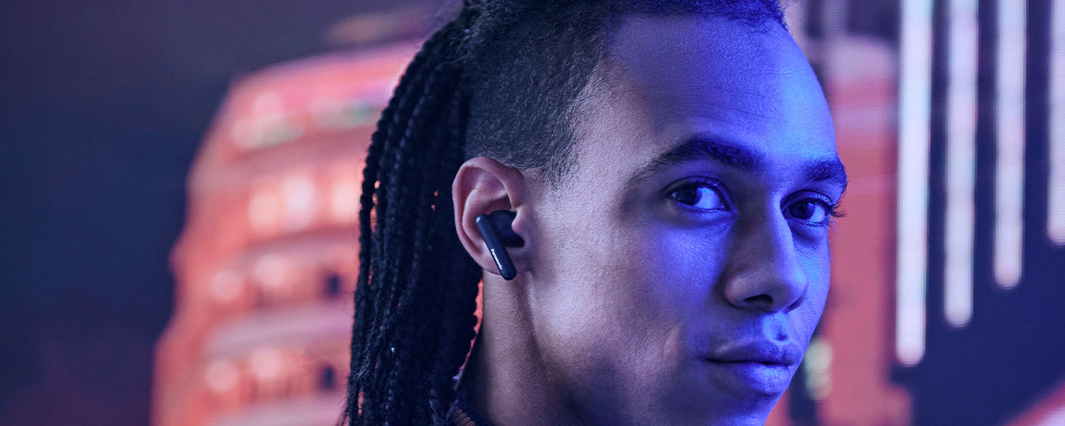 close-up of a man wearing Panasonic earbuds