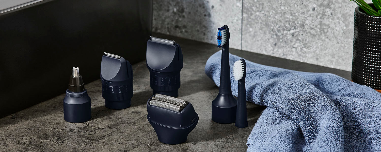 Panasonic MultiShape attachments including a shaver head, toothbrush head, body trimmer, beard trimmer and nose hair trimmer sit on a bathroom counter