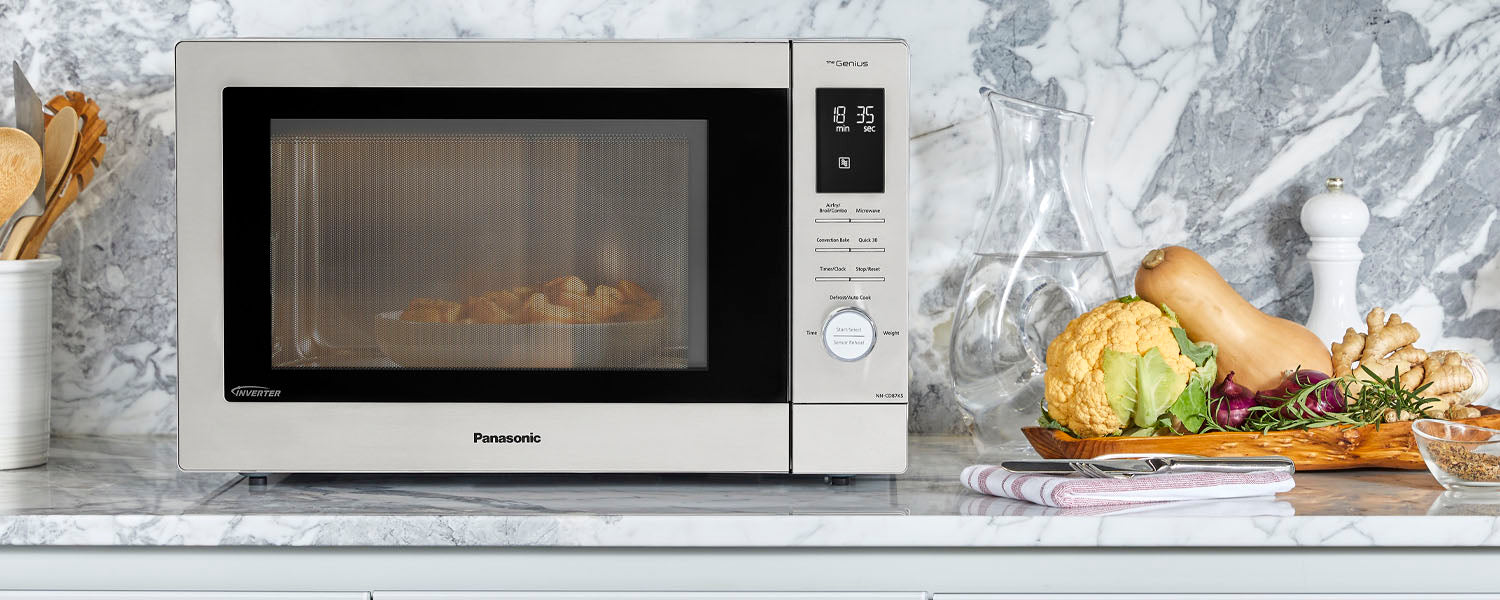 Panasonic mulit-oven cooks squash sitting on top of a marble countertop with fresh vegetables to the side