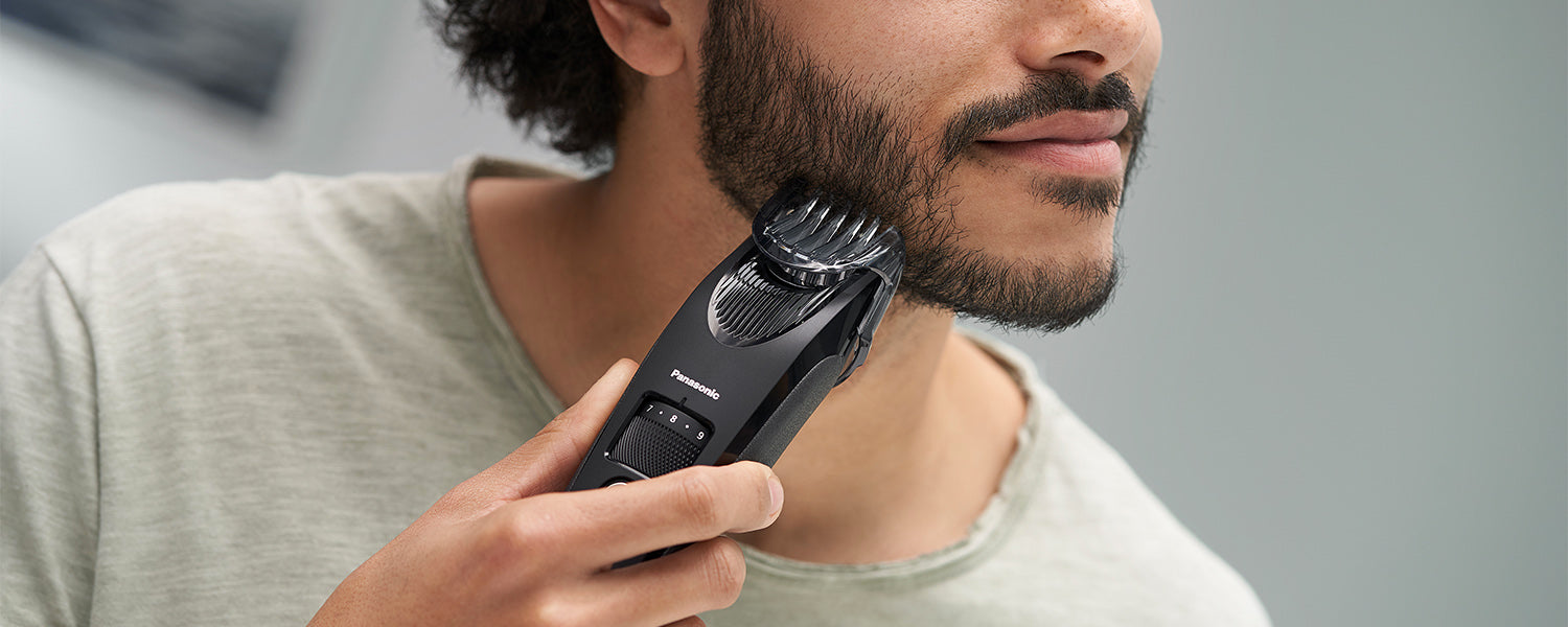man trimming his beard with a Panasonic Trimmer